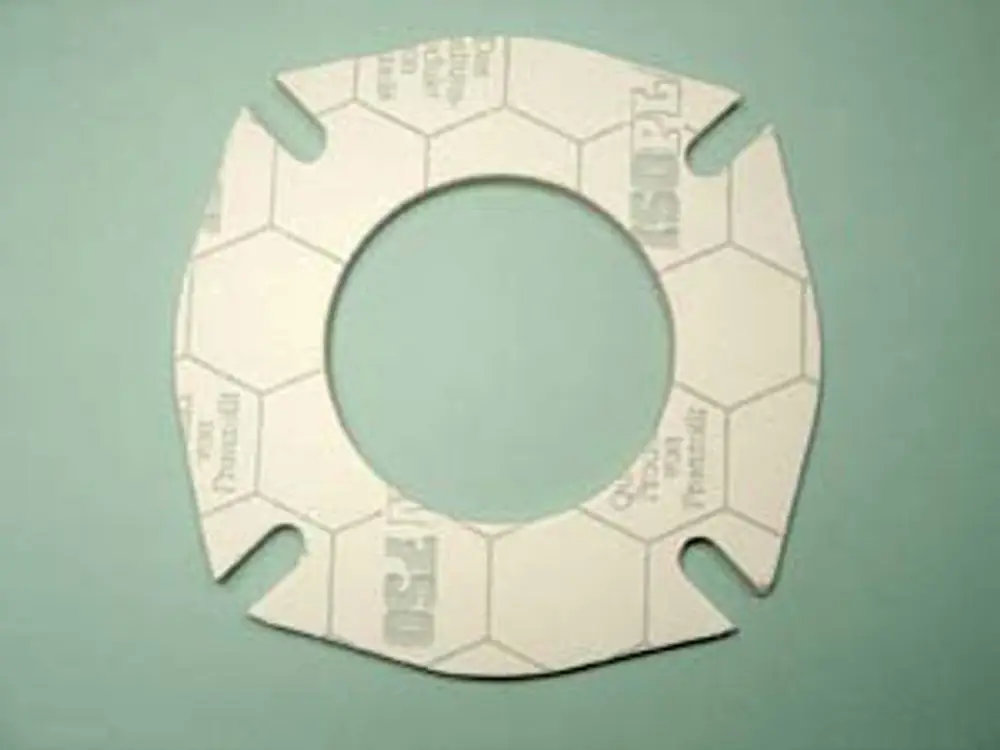 Dichtung aus einem Material mit hexagonalem Muster, verwendet in Heizsystemen, möglicherweise von Remeha, mit einem kreisförmigen Loch in der Mitte und Ausschnitten an den Seiten.